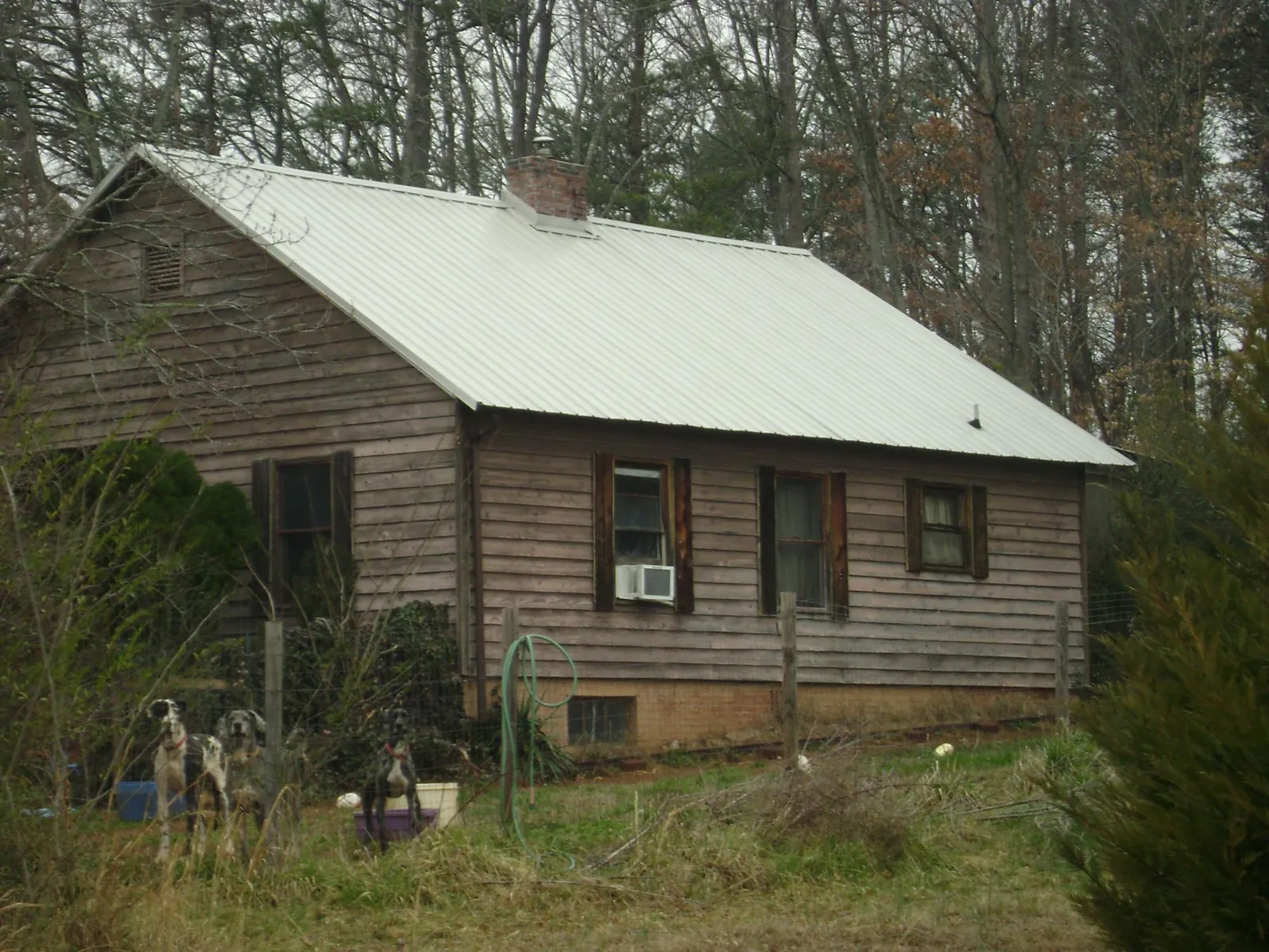 White metal roof on an old wood sided farmhouse, from a Metal Roof Installation job in Carmichaels